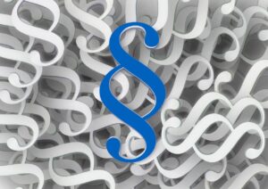 lakipykälämerkkejä, yksi edessä sinisellä, muut valkoisella.